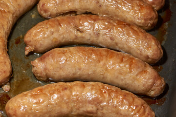 Sausages with cheese, baked in the oven. Close-up.