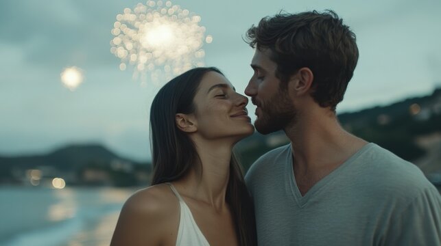 Romantic couple enjoying fireworks on a beach during a serene evening