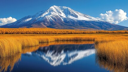 Majestic snow-capped mountain reflected in tranquil autumnal lake
