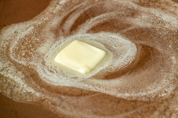 Butter melting in a pan. The creamy yellow square melts into a sizzle, preparing for delicious cooking. Food photography close-up.