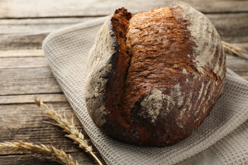 Freshly baked bread and spikes on wooden table, closeup