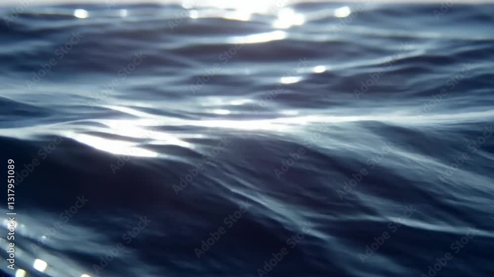 Poster serene view of ocean waves gently rippling under sunlight, creating calming and reflective atmospher