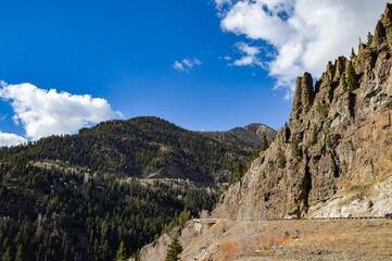 Mountain ranges and trees on a clear partly-cloudy sunny day in southwestern Colorado, USA