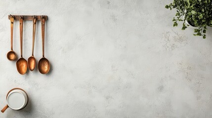 Copper measuring spoons hanging from hooks, vintage kitchen accessories, white minimalist setting