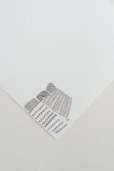 corner of textured paper with scribbles on blank paper