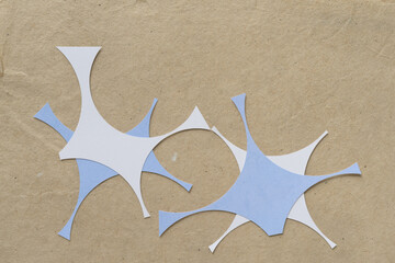 abstract paper shapes with curved edges arranged on plain brown paper