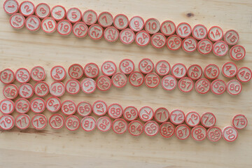 wooden tokens with red accents on a wood surface