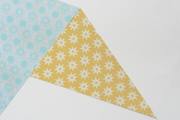 machine-cut geometric shapes (triangles) with pattern on blank paper