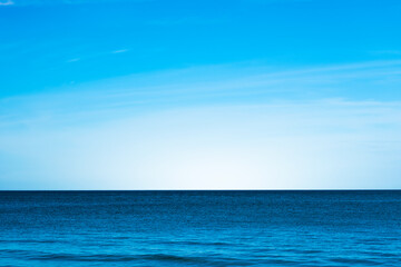 Obraz premium Nature of the beach and sea Summer with sunshine, sandy beaches, clear blue waters sparkling against the blue sky. On an island with good ecology and environment Background for summer vacation