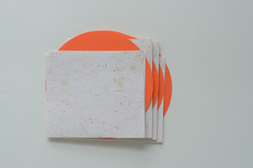 pile of folded cards and circles with staggered effect on blank paper