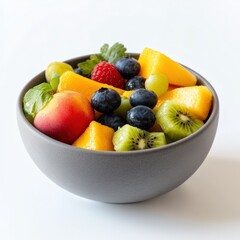 Fresh fruit salad in a bowl with strawberries, kiwi, orange, apple, melon, pineapple, and berries