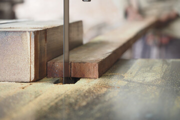 Woodworking process in a workshop with saw cutting lumber