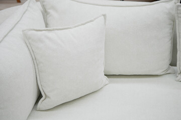 Cozy white sofa with soft pillows perfect for relaxation