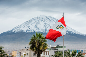Peruvian flag with the background of the Misti volcano in Arequipa, Peru