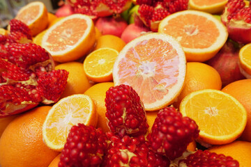 Vibrant display of fresh citrus and pomegranate fruits on market table