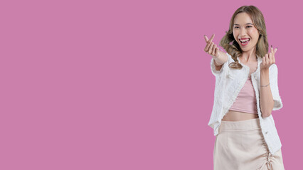 A woman is smiling and pointing to the camera. She is wearing a white shirt and white shorts