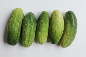 Fresh uncut cucumber, isolated on white background