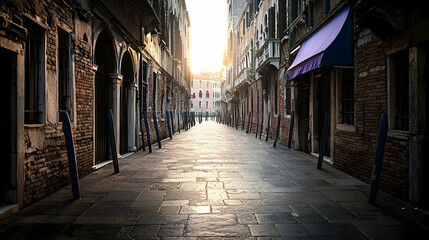 Obraz premium Early Morning Sunlight Illuminates A Narrow Venetian Street With Cobblestone Pavement And Traditional Architecture In Italy