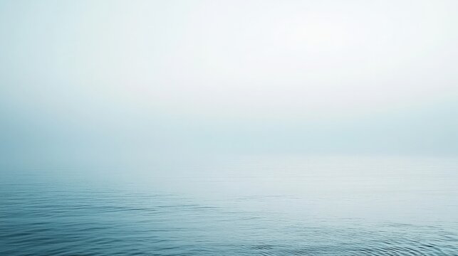 Serene seascape featuring calm waters merging into a misty horizon backdrop