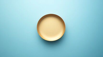 Elevated simplicity featuring a luxurious gold colored tray against a serene turquoise backdrop