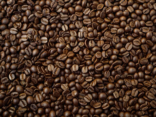 A steaming cup of coffee surrounded by scattered coffee beans.