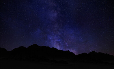 Beautiful night landscape, Bright Milky Way galaxy over the mountains, starry sky. Night starry sky background, universe . Mountains, stars, zodiacal light and the Milky Way on a beautiful night sky

