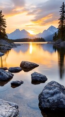 Sunrise illuminating rocky shore of Maligne Lake in Jasper National Park