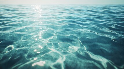 Obraz premium Calm blue ocean surface reflecting bright sunlight on a clear day