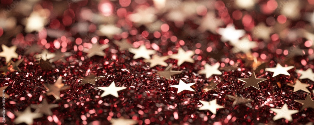 Poster a shimmering surface covered in shiny red glitter and silver star shapes, creating a festive and cel