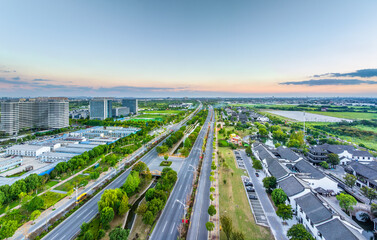 Aerial view of a suburban area with roads and traditional houses