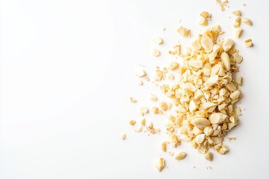 Heap of crushed macadamia nuts on a white background in top down view for recipe ingredient ideas