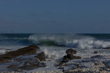 A huge wave driven by an approaching cyclone or hurricane, breaks and crashes wildly into the boiling storm surf, trailing wind blown spray as it breaks at Snapper Rocks on the Gold Coast, Australia.
