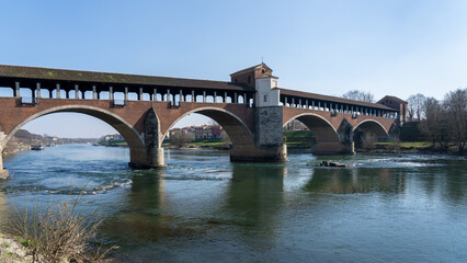 Fototapeta premium Pavia, Italy. Amazing view of the Ponte Coperto (Covered Bridge) or the Ponte Vecchio (Old Bridge) over the Ticino river
