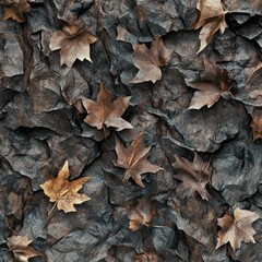 Dried brown maple leaves on dark textured surface.