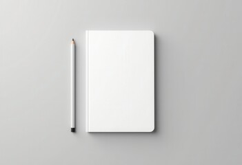 Book mockup with pencil on gray background.