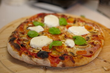 Homemade pizza on the wooden cutting board