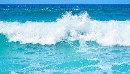 Fototapeta premium Cresting ocean waves on a sunny day with turquoise wate