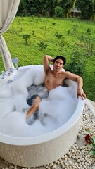 Handsome Man Relaxing in a Bubble Bath at a Chiang Mai Resort in his Honeymoon trip