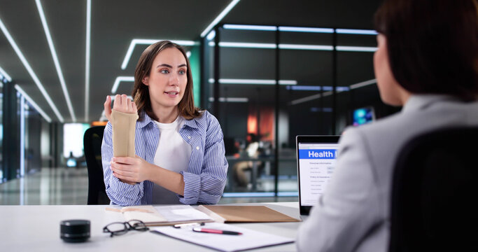 Woman seeking worker injury compensation with insurance lawyer after accident