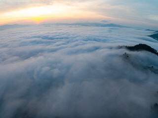 Drone aerial view of landscape fog over mountains in sunrise sky,High angle view over countryside at Southeast asia,Phang Nga Thailand,Wide angle view nature landscape