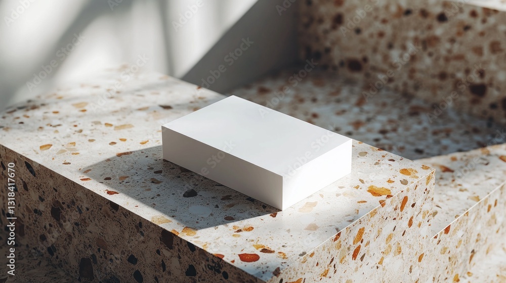Poster A sleek, white rectangular block rests on a beautifully patterned stone surface illuminated by soft sunlight. The contrast enhances the elegance of minimalistic design, inviting attention