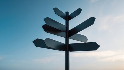 Empty dark metal signpost set against a sky background.