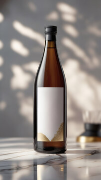 Elegant sake bottle with blank label and delicate golden accents, perfect for premium product branding, set on marble surface.