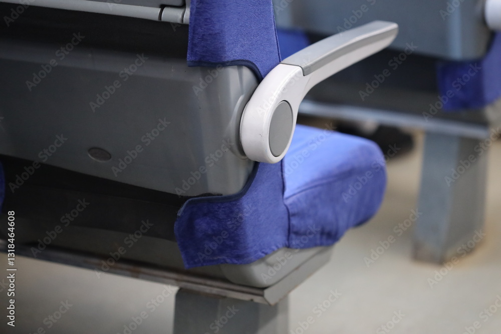 Poster a close-up view of a train seat showing its design and details.