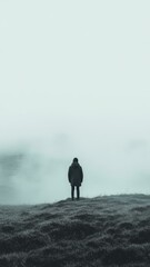 A Solitary Figure Stands at the Edge of a Foggy Field
