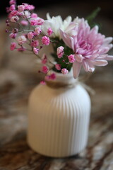A decorative vase filled with fresh pink and white flowers.