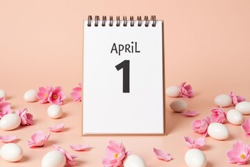 A Simple April 1 Calendar Page Surrounded by White Eggs and Pink Blossoms on a Soft Peach Background, Signifying Spring and Celebration of April Fools' Day