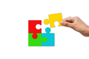 Hands putting together jigsaw puzzle pieces. Teamwork for success. Business cooperation concept. Isolated on white paper background.