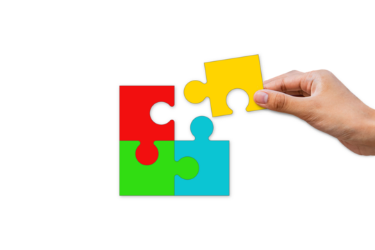 Hands putting together jigsaw puzzle pieces. Teamwork for success. Business cooperation concept. Isolated on white paper background.