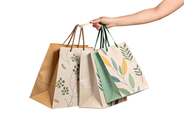 female hand holding three Paper shopping bags isolated on transparent background generative ai